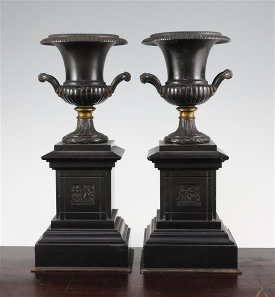 A pair of late 19th century bronze and ormolu campana shaped urns, 12in.